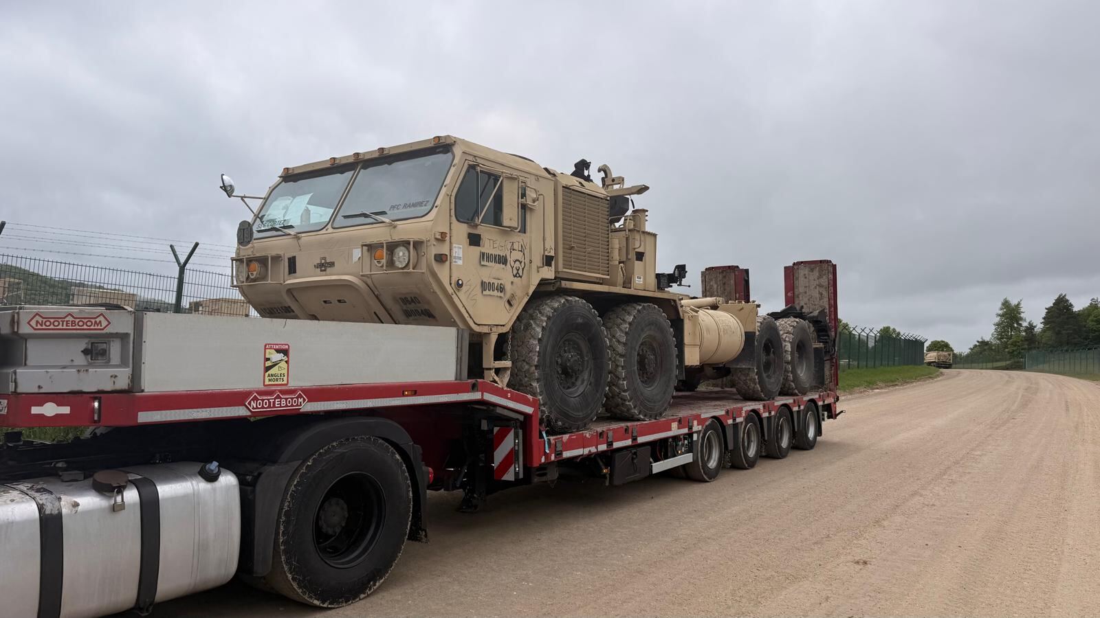 Heavy tactical truck secured on a lowloader trailer