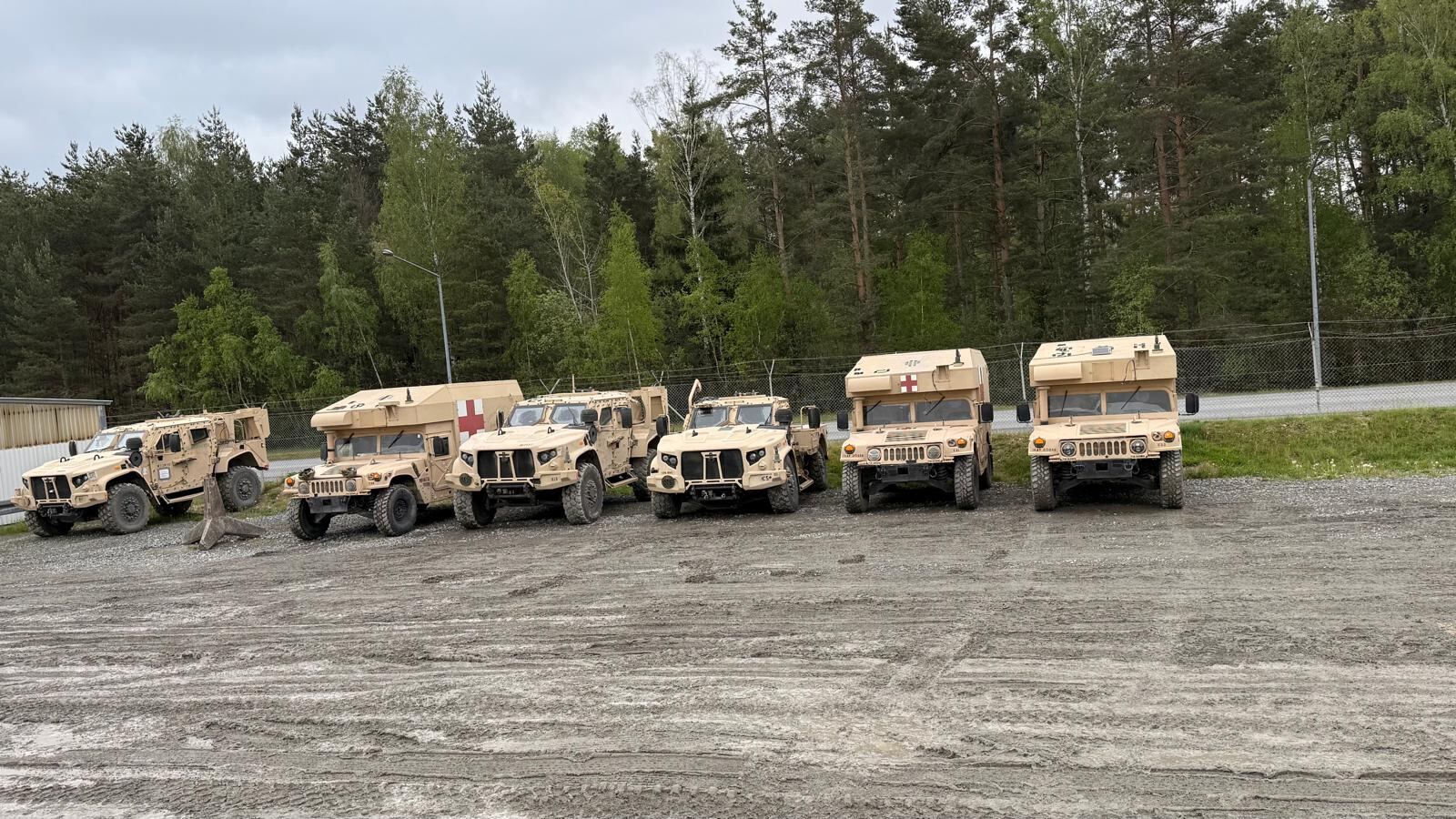 Row of light tactical vehicles in a staging area